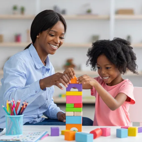 Mom and daughter playing with blocks.