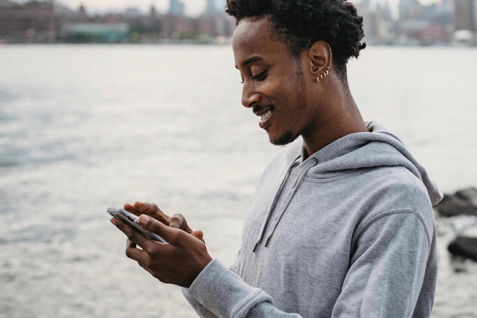 Man smiling at his phone.