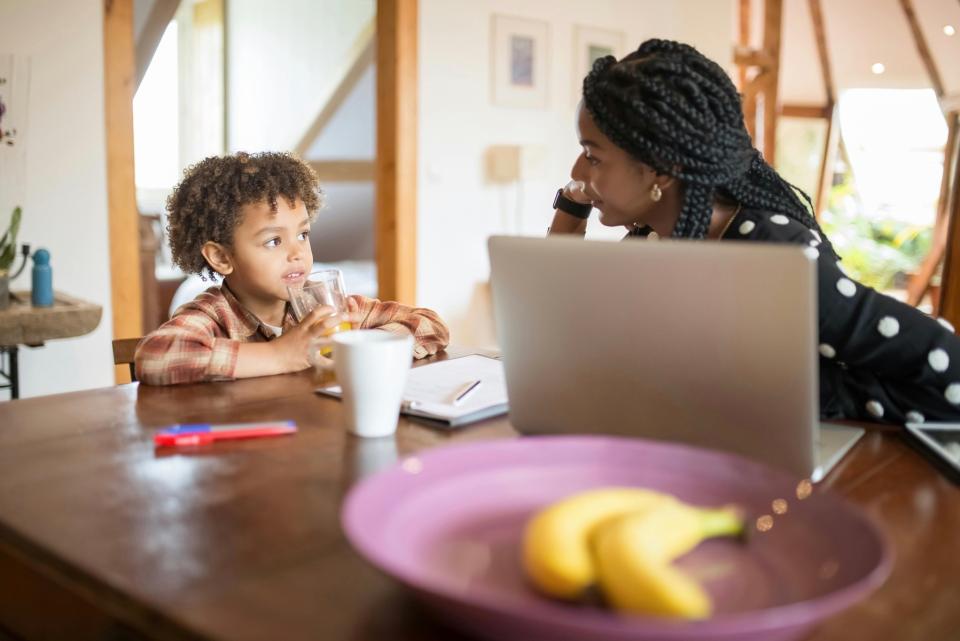 Mom and young daughter talking at table