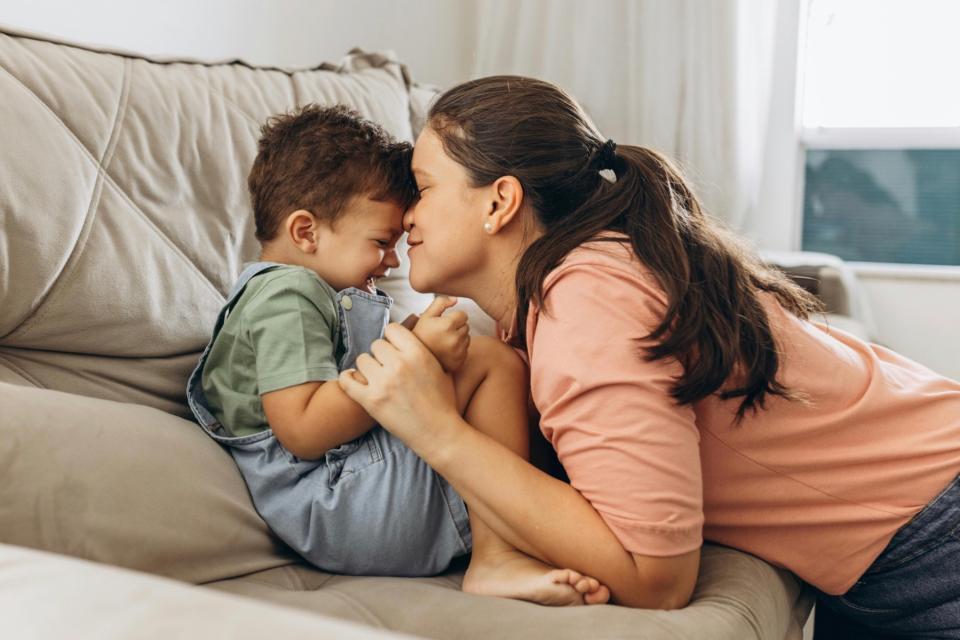 Mom cuddling her son.